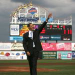 Presidential look alike Randall West waves at the crowd after throwing the ceremonial first pitch.